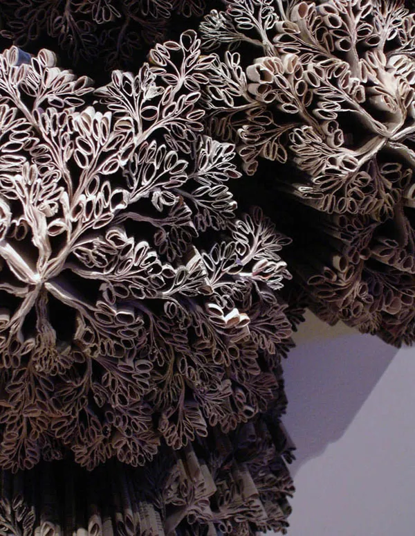 Close-up of intricate brown and white sculptural forms resembling coral or floral clusters, with a soft muted atmosphere